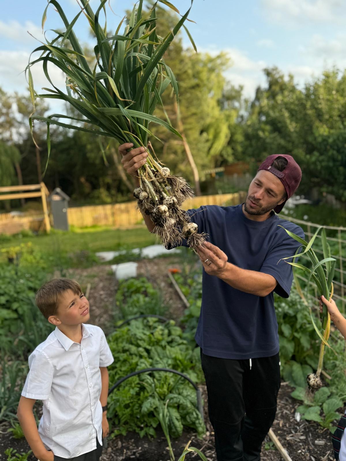 The Happy Carrot's founder harvesting home-grown produce in the garden